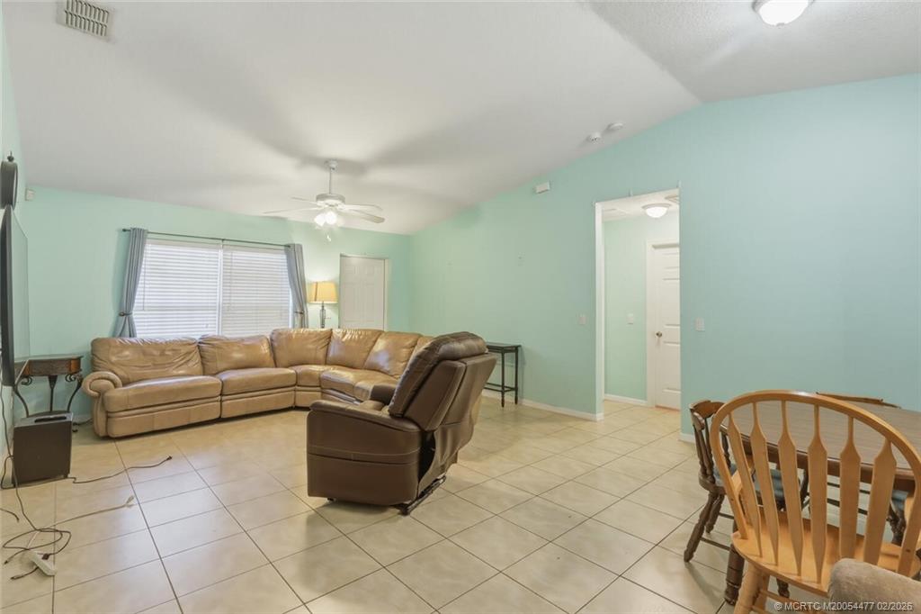 726 Southwest Bond Road Port St. Lucie, FL 34953 - Photo 9 of 31 a living room with furniture and a dining table