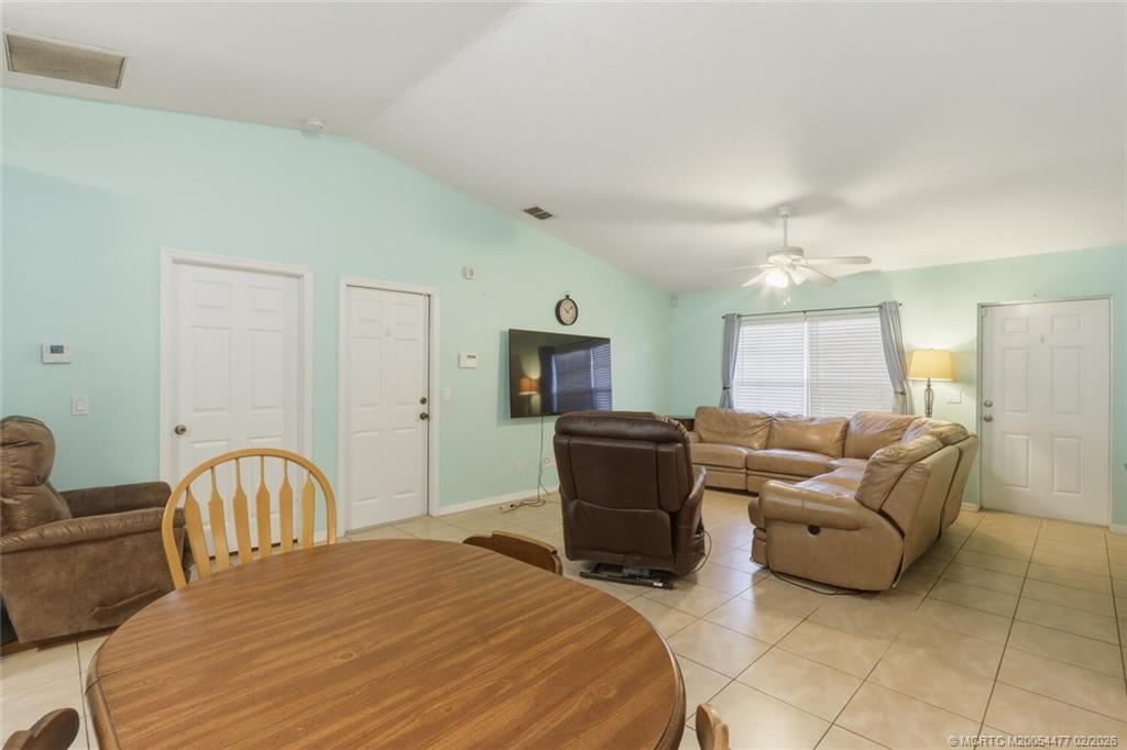 726 Southwest Bond Road Port St. Lucie, FL 34953 - Photo 10 of 31 a bedroom with a bed and a couch