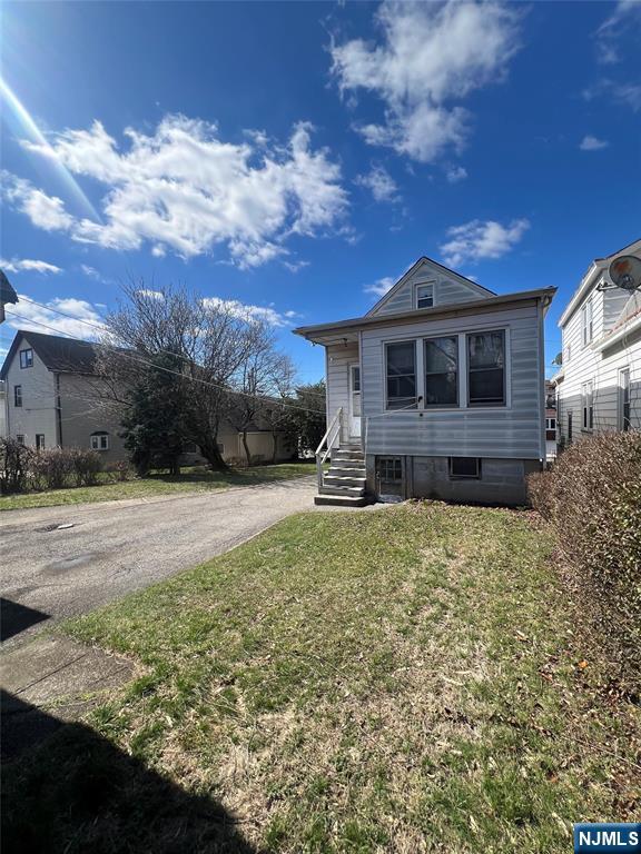 44 Scudder Street Garfield, NJ 07026 - Photo 16 of 21 a front view of a house with a yard