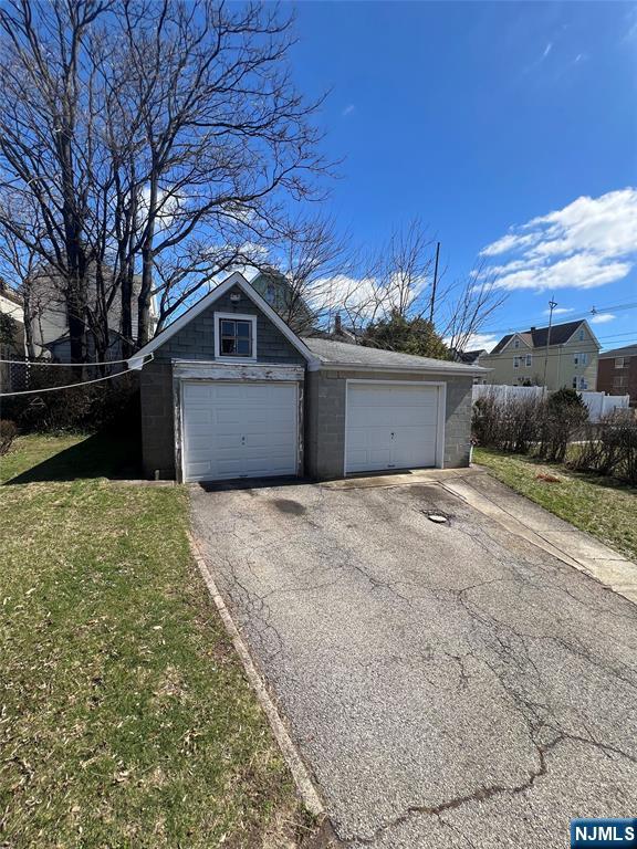44 Scudder Street Garfield, NJ 07026 - Photo 21 of 21 a front view of a house with a yard and garage