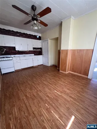 a view of a kitchen with a sink and a stove top oven