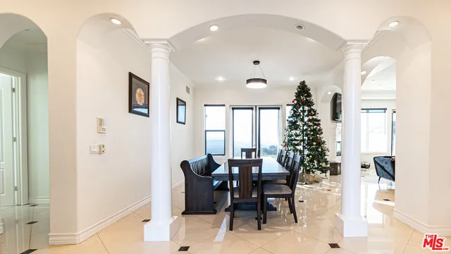 a view of a dining room with furniture and chandelier