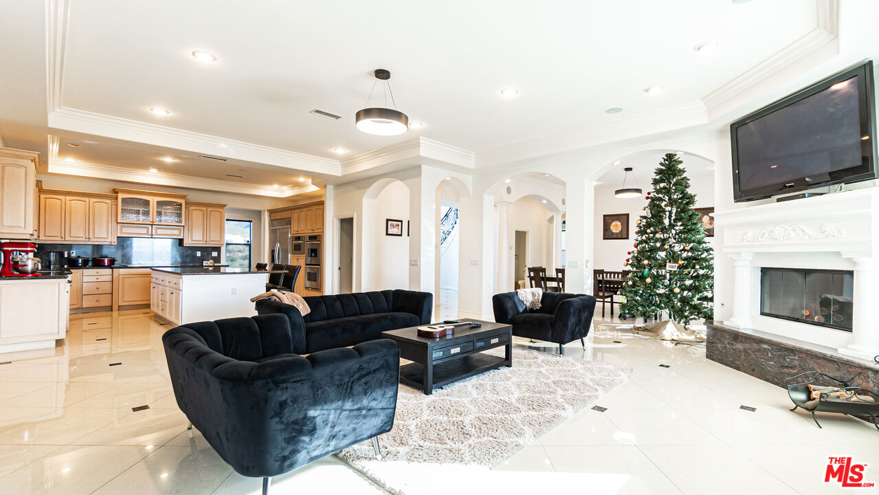 8321 Overview Court Yucaipa, CA 92399 - Photo 15 of 75 a living room with furniture a flat screen tv and a fireplace