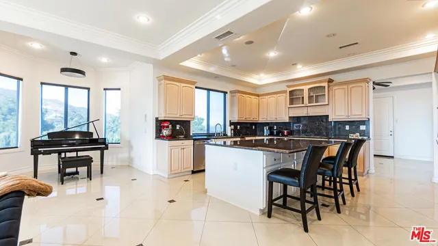 a kitchen with stainless steel appliances granite countertop a stove and cabinets