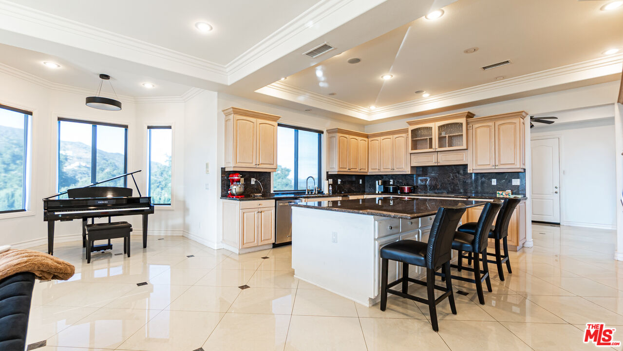8321 Overview Court Yucaipa, CA 92399 - Photo 18 of 75 a kitchen with stainless steel appliances kitchen island granite countertop a sink and cabinets