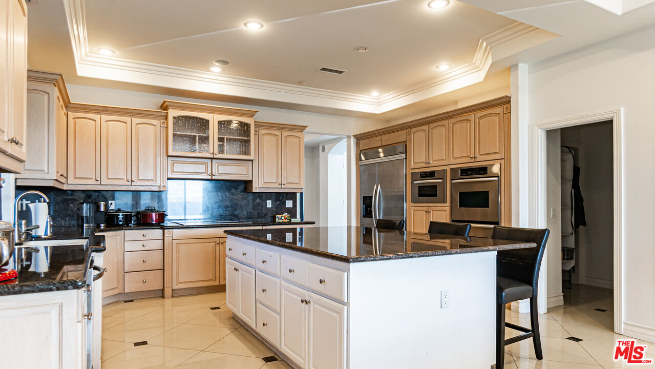 8321 Overview Court Yucaipa, CA 92399 - Photo 20 of 75 a kitchen with stainless steel appliances granite countertop a stove and cabinets