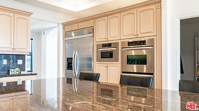 a bathroom with a granite countertop sink mirror vanity and toilet