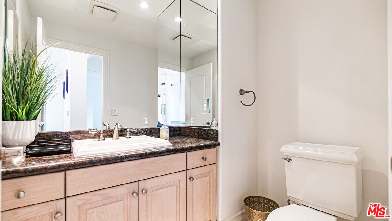 8321 Overview Court Yucaipa, CA 92399 - Photo 23 of 75 a bathroom with a granite countertop sink mirror vanity and toilet
