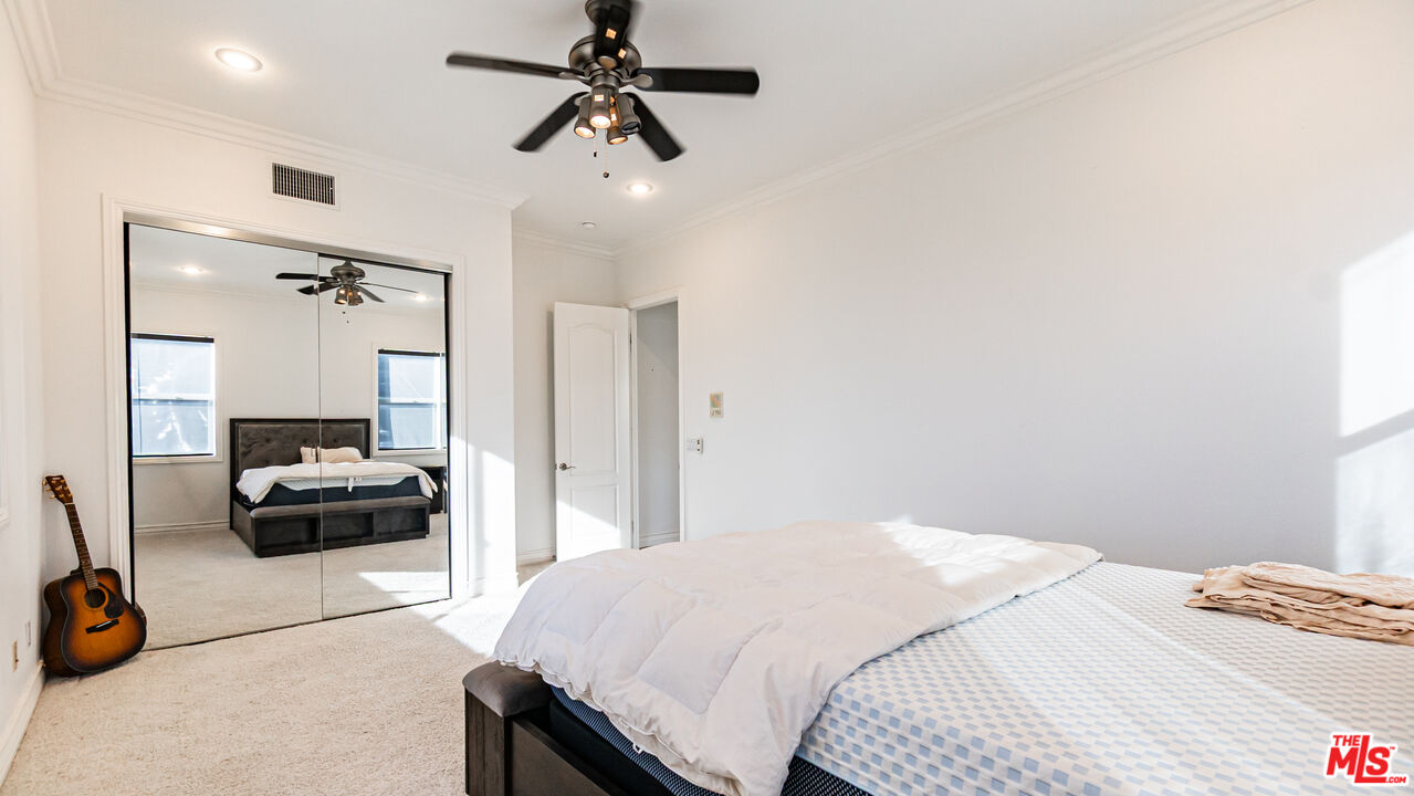 8321 Overview Court Yucaipa, CA 92399 - Photo 25 of 75 a bedroom with a bed and a chandelier