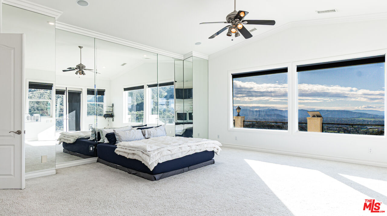 8321 Overview Court Yucaipa, CA 92399 - Photo 33 of 75 a spacious bedroom with a bed couch and large window