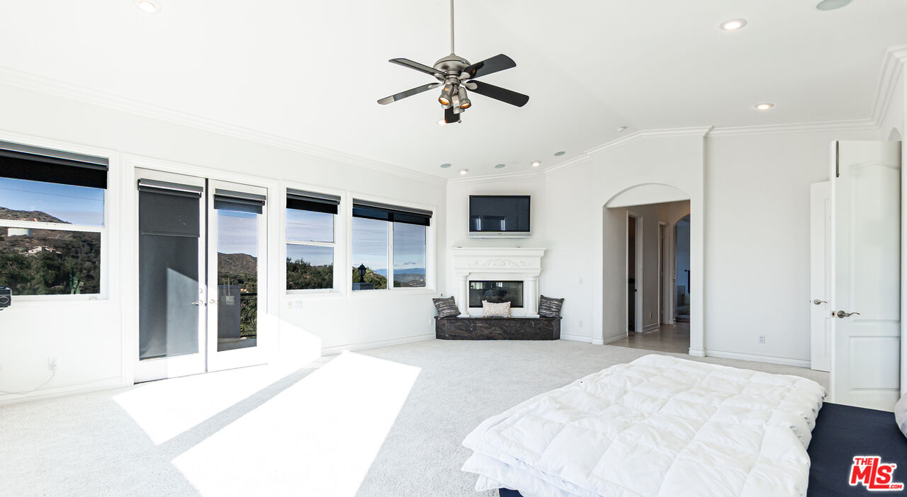 8321 Overview Court Yucaipa, CA 92399 - Photo 34 of 75 a living room with furniture window and a fireplace