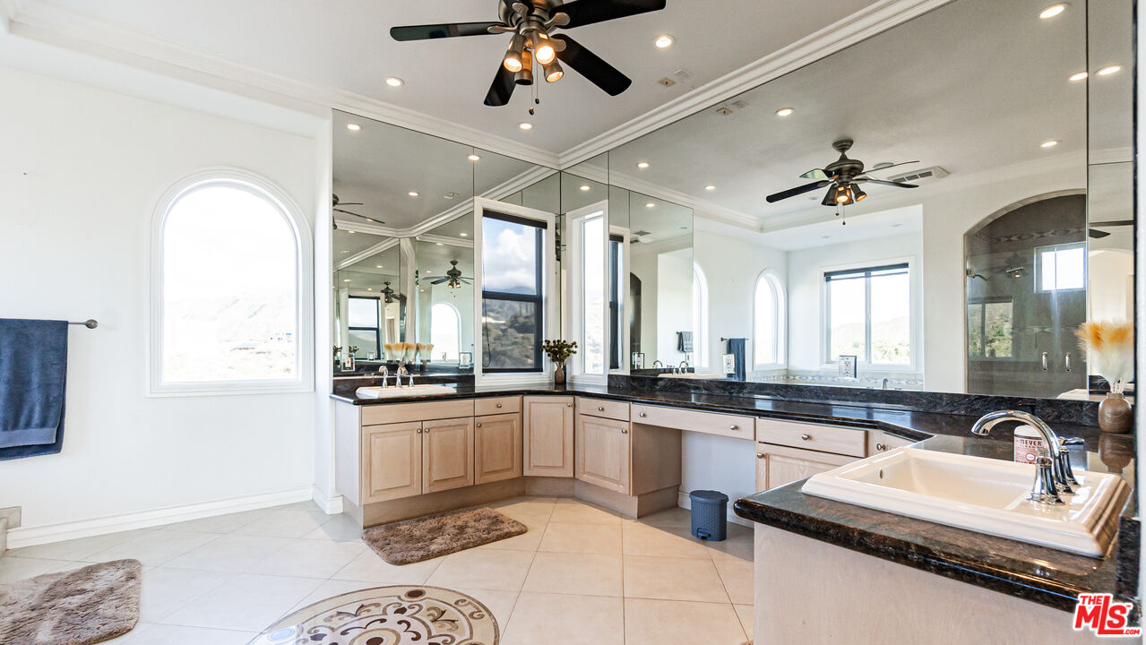 8321 Overview Court Yucaipa, CA 92399 - Photo 36 of 75 a large kitchen with granite countertop a sink stainless steel appliances and furniture