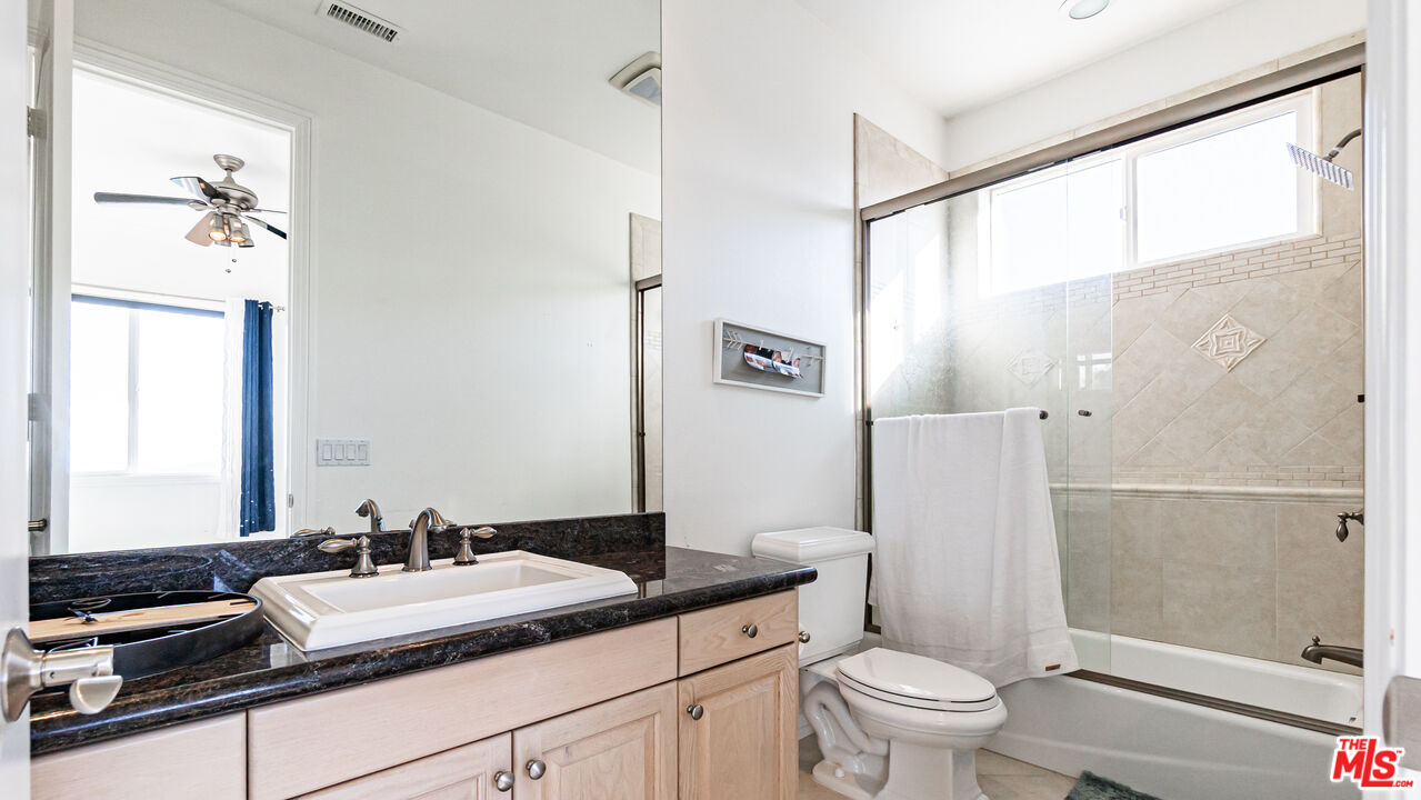 8321 Overview Court Yucaipa, CA 92399 - Photo 47 of 75 a bathroom with a granite countertop sink toilet and shower