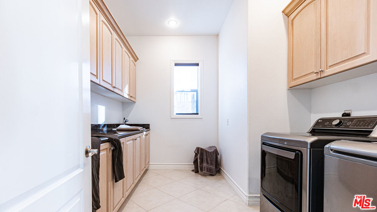 8321 Overview Court Yucaipa, CA 92399 - Photo 50 of 75 a view of a storage and utility room with washer and dryer
