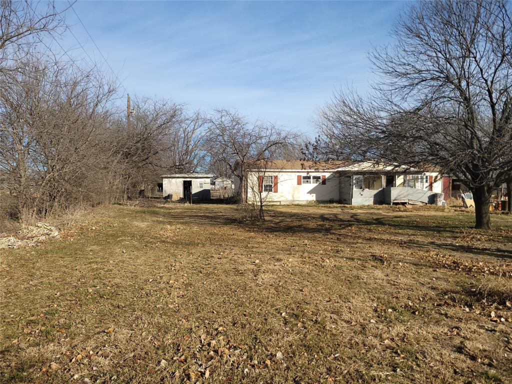 10936 Sam Reynolds Road Justin, TX 76247 - Photo 2 of 11 a front view of a house with a yard