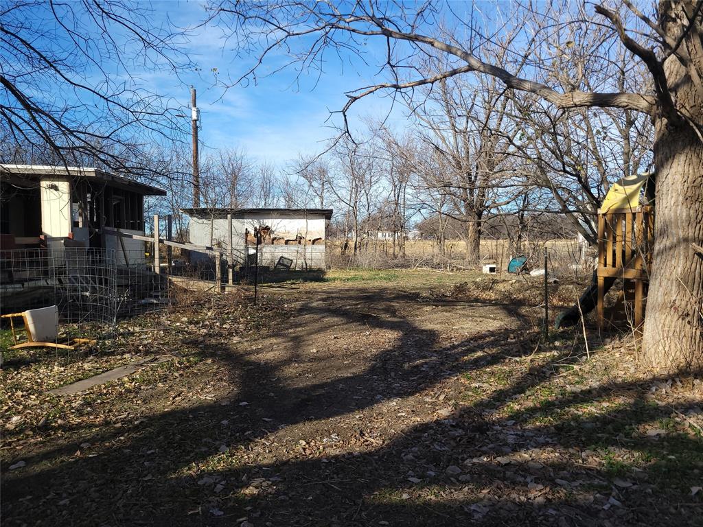 10936 Sam Reynolds Road Justin, TX 76247 - Photo 5 of 11 a view of a yard with car parked