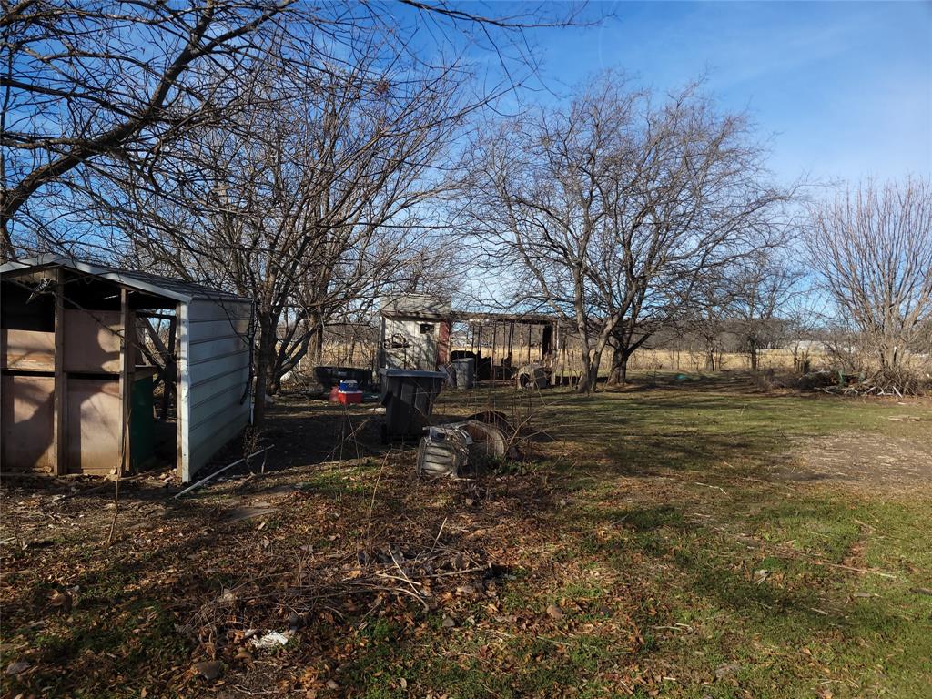 10936 Sam Reynolds Road Justin, TX 76247 - Photo 7 of 11 a view of a backyard with large trees