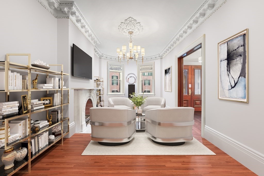 a living room with fireplace furniture and a chandelier