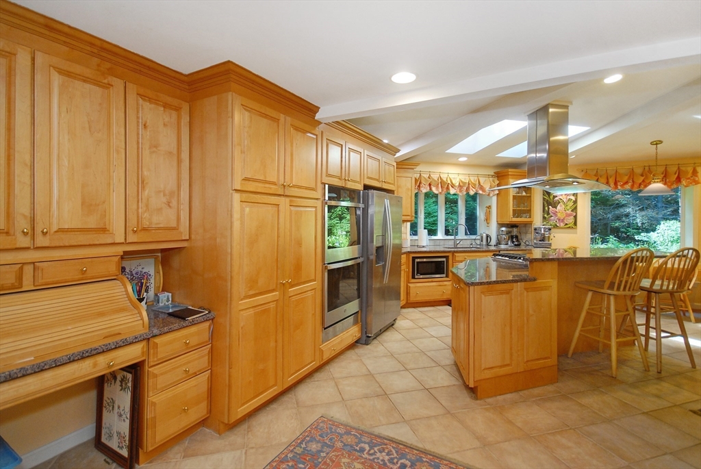 41 Clarissa Road Chelmsford, MA 01824 - Photo 14 of 26 a kitchen with stainless steel appliances granite countertop a refrigerator a stove and a sink dishwasher with wooden cabinets