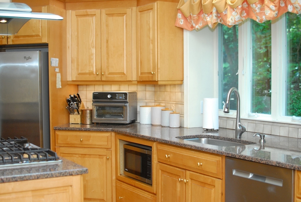 41 Clarissa Road Chelmsford, MA 01824 - Photo 16 of 26 a kitchen with stainless steel appliances granite countertop a sink stove and refrigerator