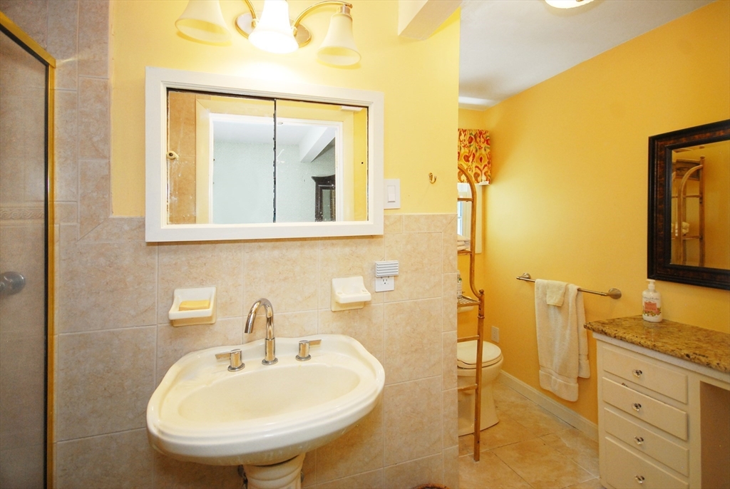41 Clarissa Road Chelmsford, MA 01824 - Photo 22 of 26 a bathroom with a sink and a mirror
