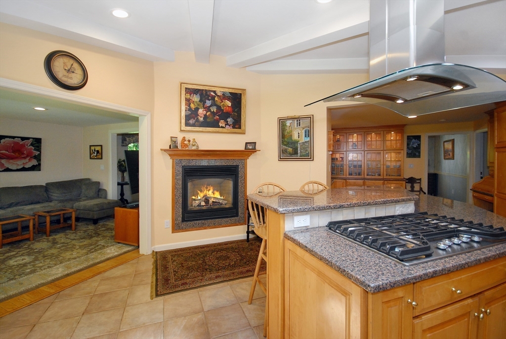 41 Clarissa Road Chelmsford, MA 01824 - Photo 10 of 26 a kitchen with kitchen island granite countertop a stove and a fireplace