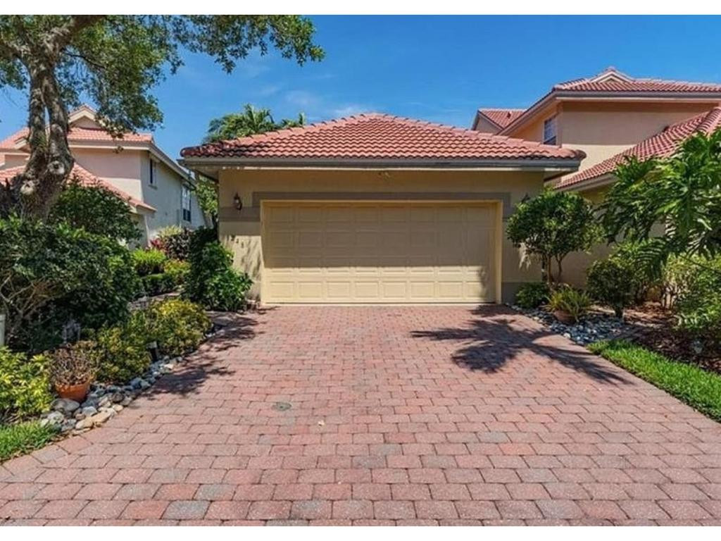 248 Napa Ridge Road East, Unit E18 Naples, FL 34119 - Photo 1 of 1 a front view of a house with garden