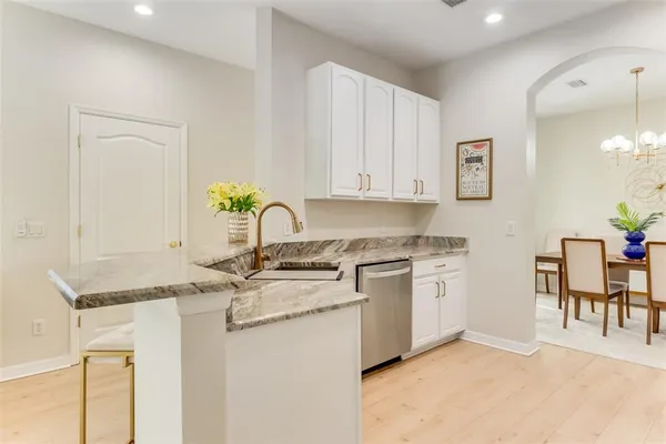 a kitchen with stainless steel appliances granite countertop a stove a sink and a granite counter tops