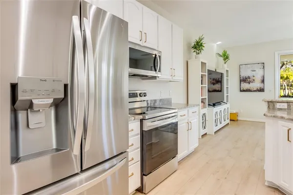 a kitchen with stainless steel appliances a refrigerator sink and stove