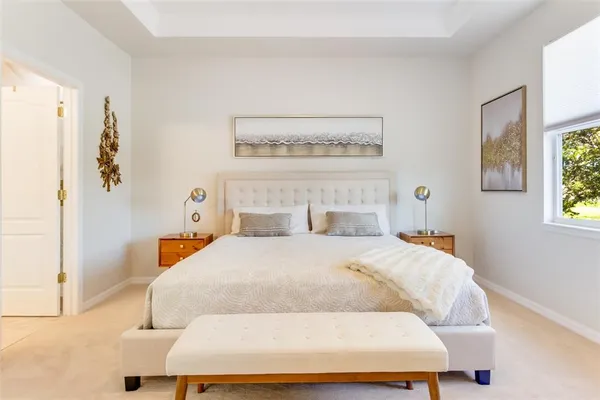 a bedroom with a bed and painting on the wall