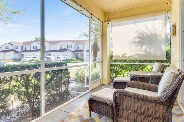 a balcony with furniture and a floor to ceiling window