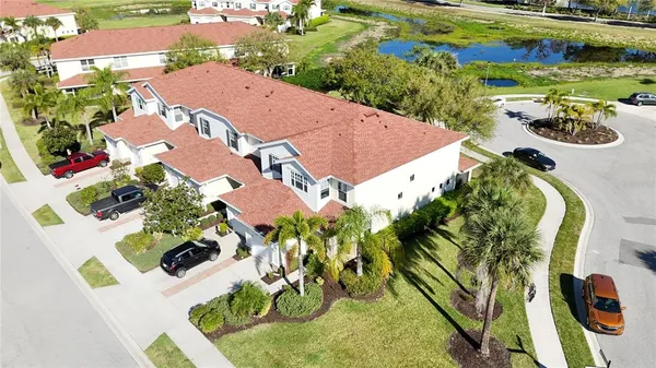 an aerial view of a house with a yard and lake view
