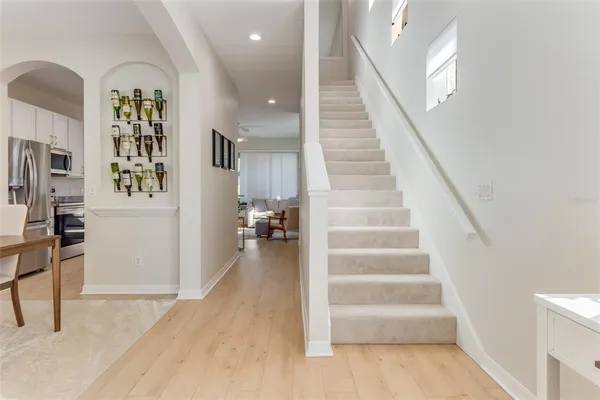 a view of entryway and hall with wooden floor