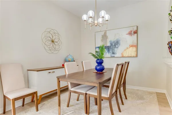 a view of a dining room with furniture and chandelier
