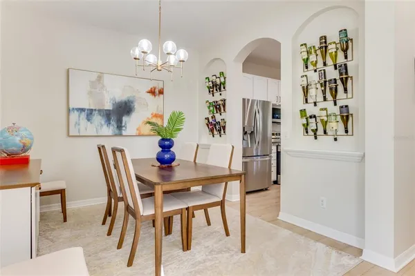 a dining room with furniture and chandelier