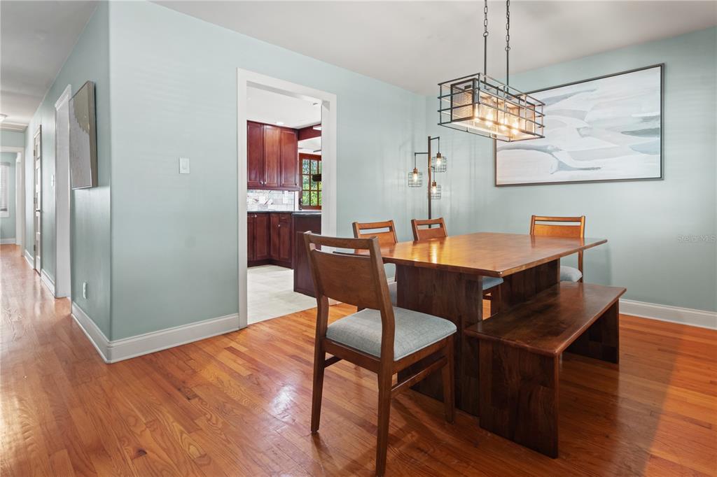 6515 Dimarco Road Tampa, FL 33634 - Photo 10 of 66 a dining room with furniture a chandelier and wooden floor