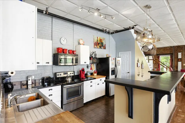 a kitchen with cabinets and window