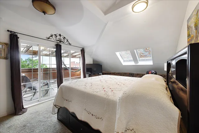 a living room with furniture a rug and a large window