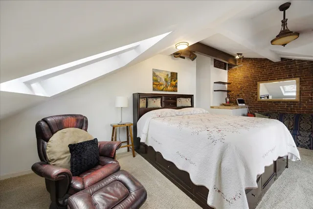 a bedroom with a large bed and a window