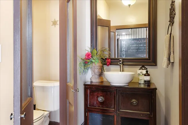 a living room with lots of furniture hardwood floor and a flat screen tv