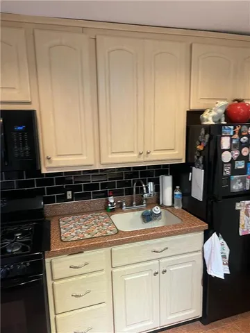 a kitchen with stainless steel appliances granite countertop a stove and a microwave