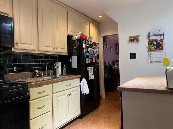 a kitchen with stainless steel appliances granite countertop a stove and a microwave