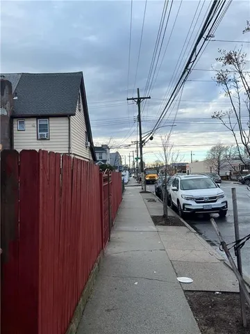 a view of a patio with table and chairs with wooden fence