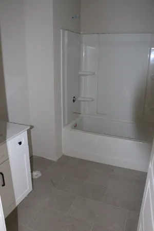 a view of a room with a ceiling fan