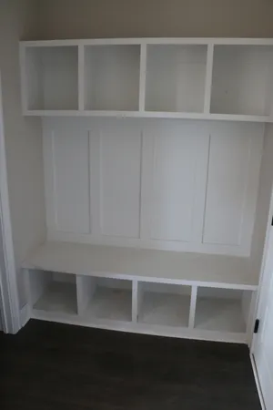 a view of empty room with cabinet and fan