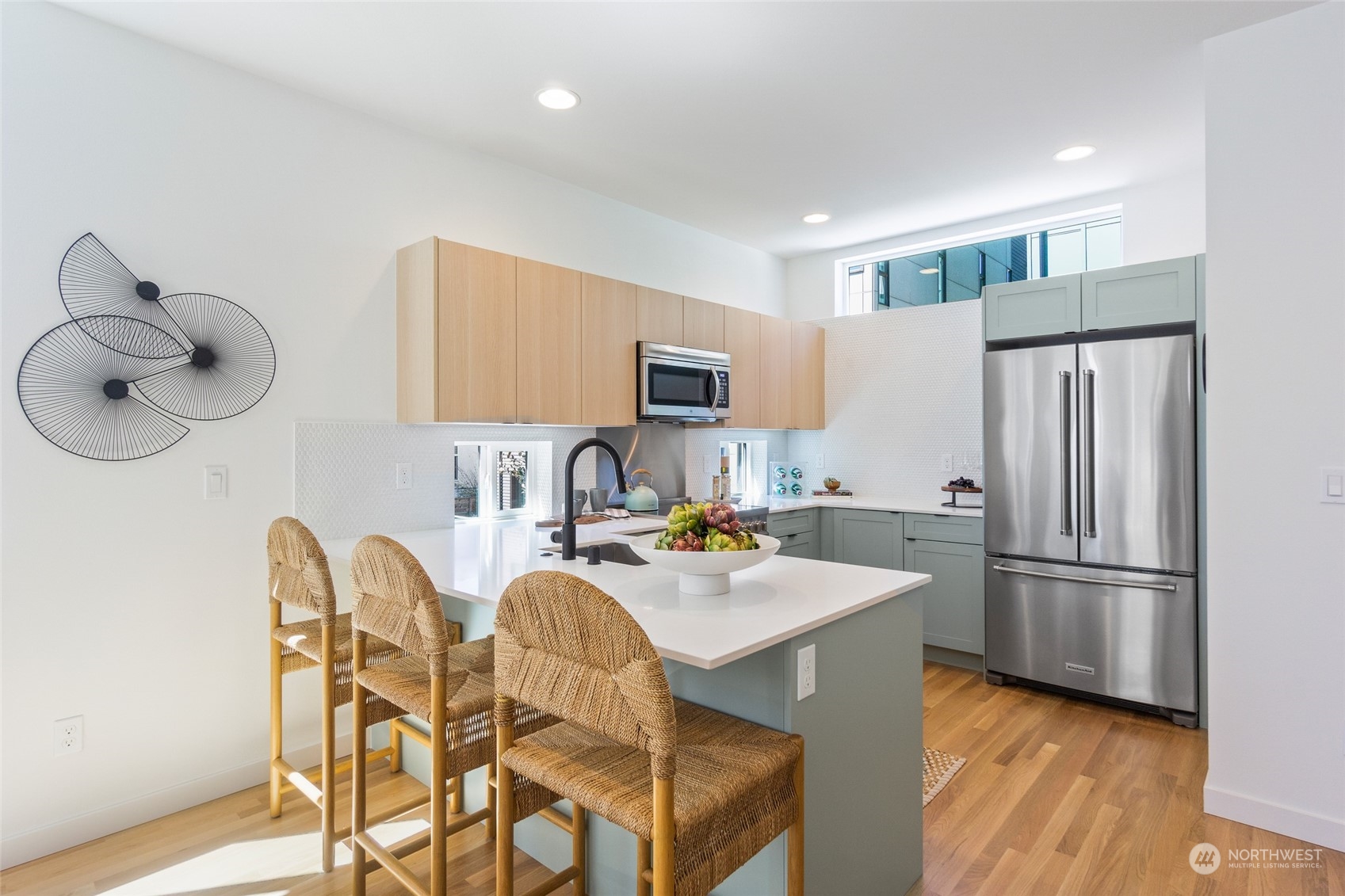 2620 Northwest 62nd Street, Unit B Seattle, WA 98107 - Photo 19 of 34 a kitchen with stainless steel appliances granite countertop a refrigerator a stove a sink and a dining table with wooden floor