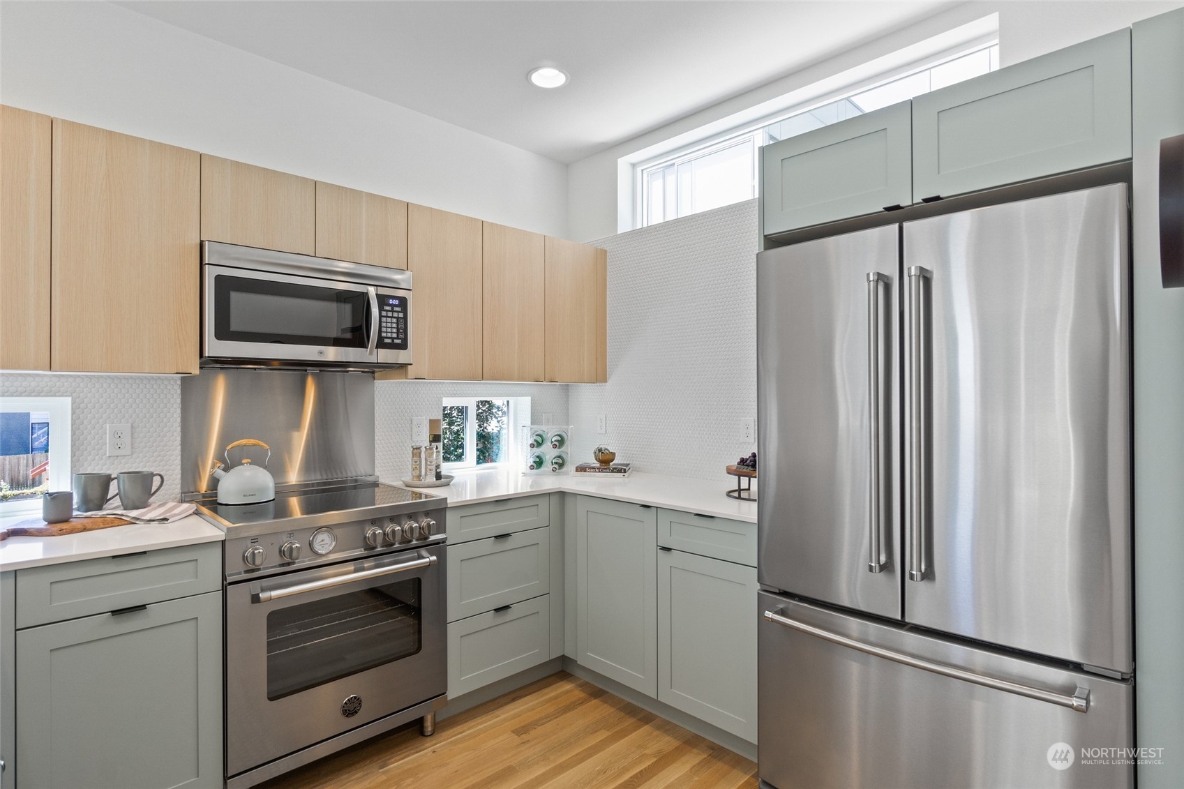 2620 Northwest 62nd Street, Unit B Seattle, WA 98107 - Photo 21 of 34 a kitchen with stainless steel appliances a refrigerator sink and microwave