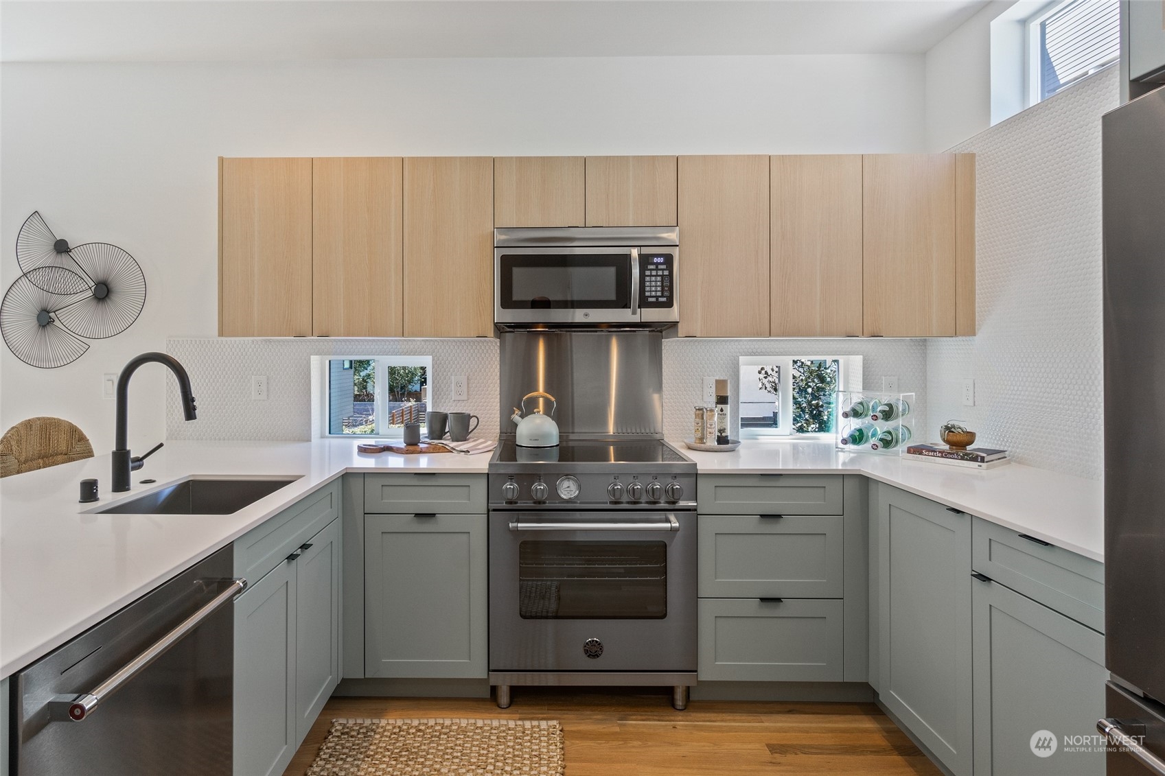 2620 Northwest 62nd Street, Unit B Seattle, WA 98107 - Photo 22 of 34 a kitchen with sink a stove and cabinets