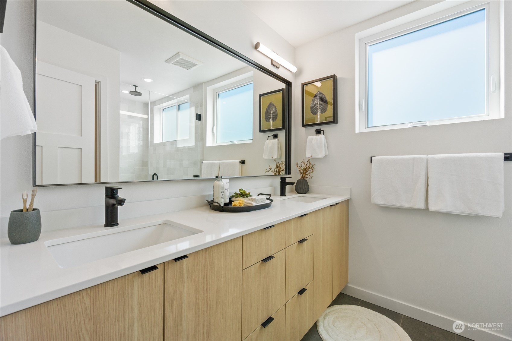 2620 Northwest 62nd Street, Unit B Seattle, WA 98107 - Photo 26 of 34 a bathroom with a sink a toilet and mirror