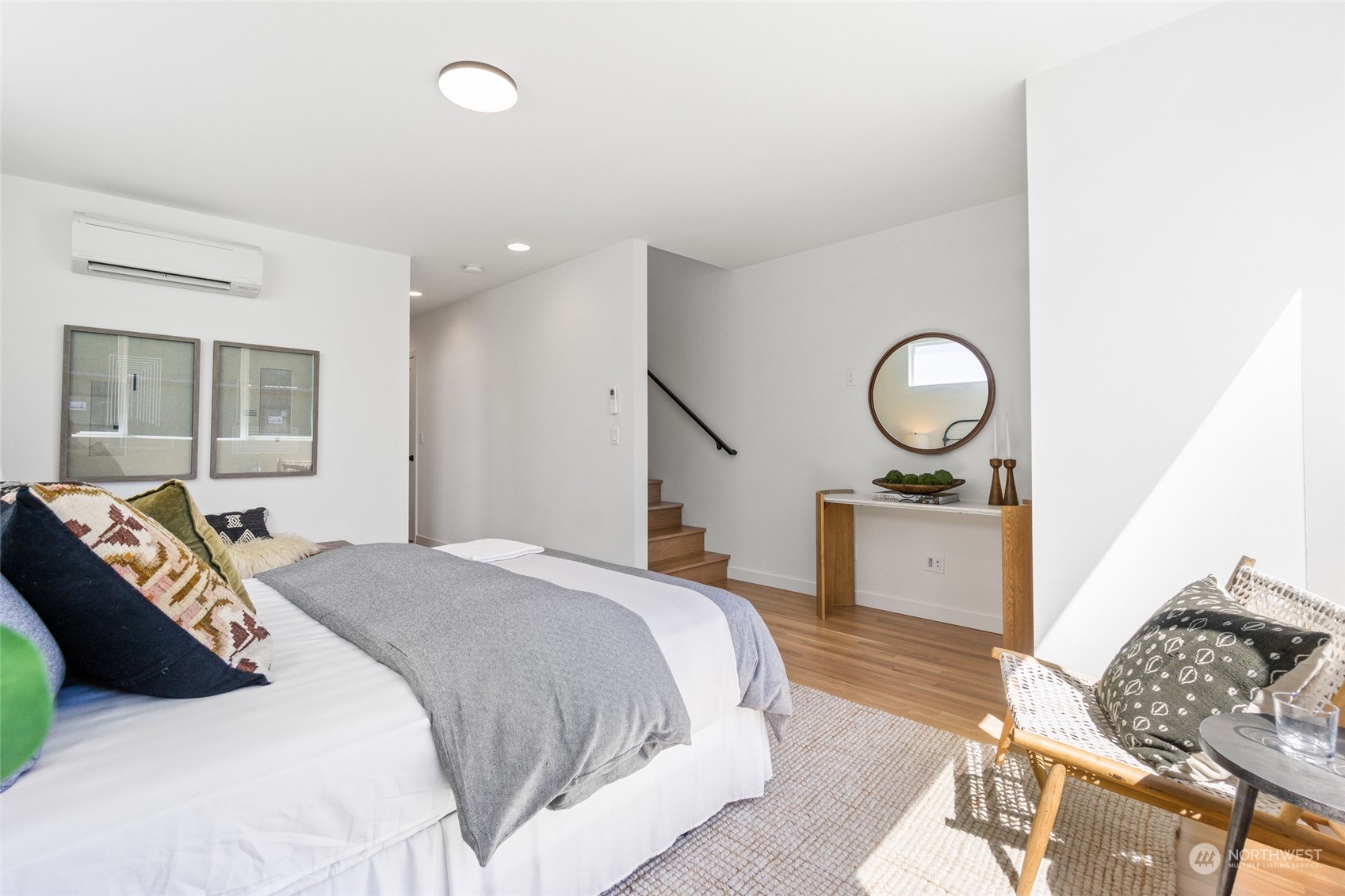 2620 Northwest 62nd Street, Unit B Seattle, WA 98107 - Photo 29 of 34 a bedroom with a bed and wooden floor